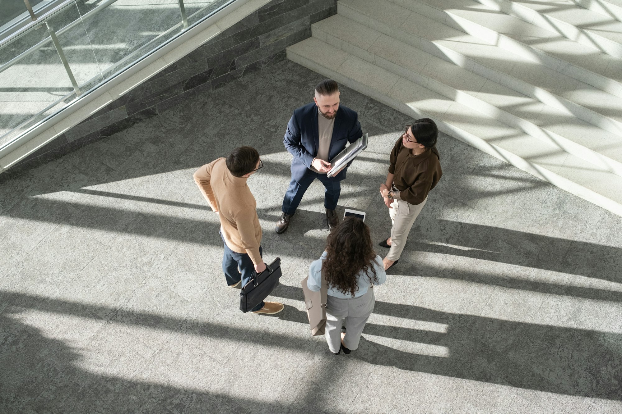 Group of contemporary delegates in formalwear having discussion