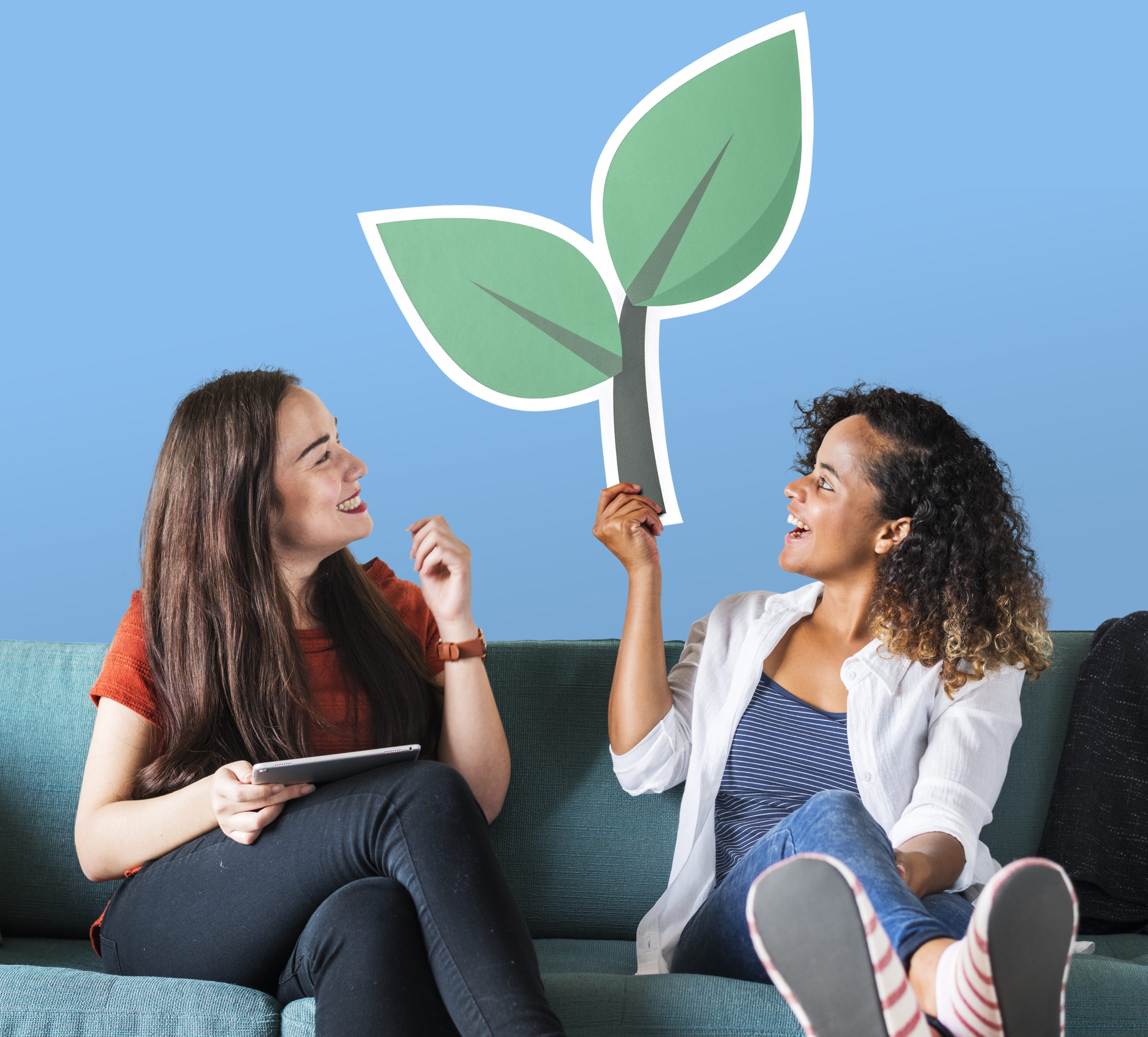 Woman holding emoticons on a couch