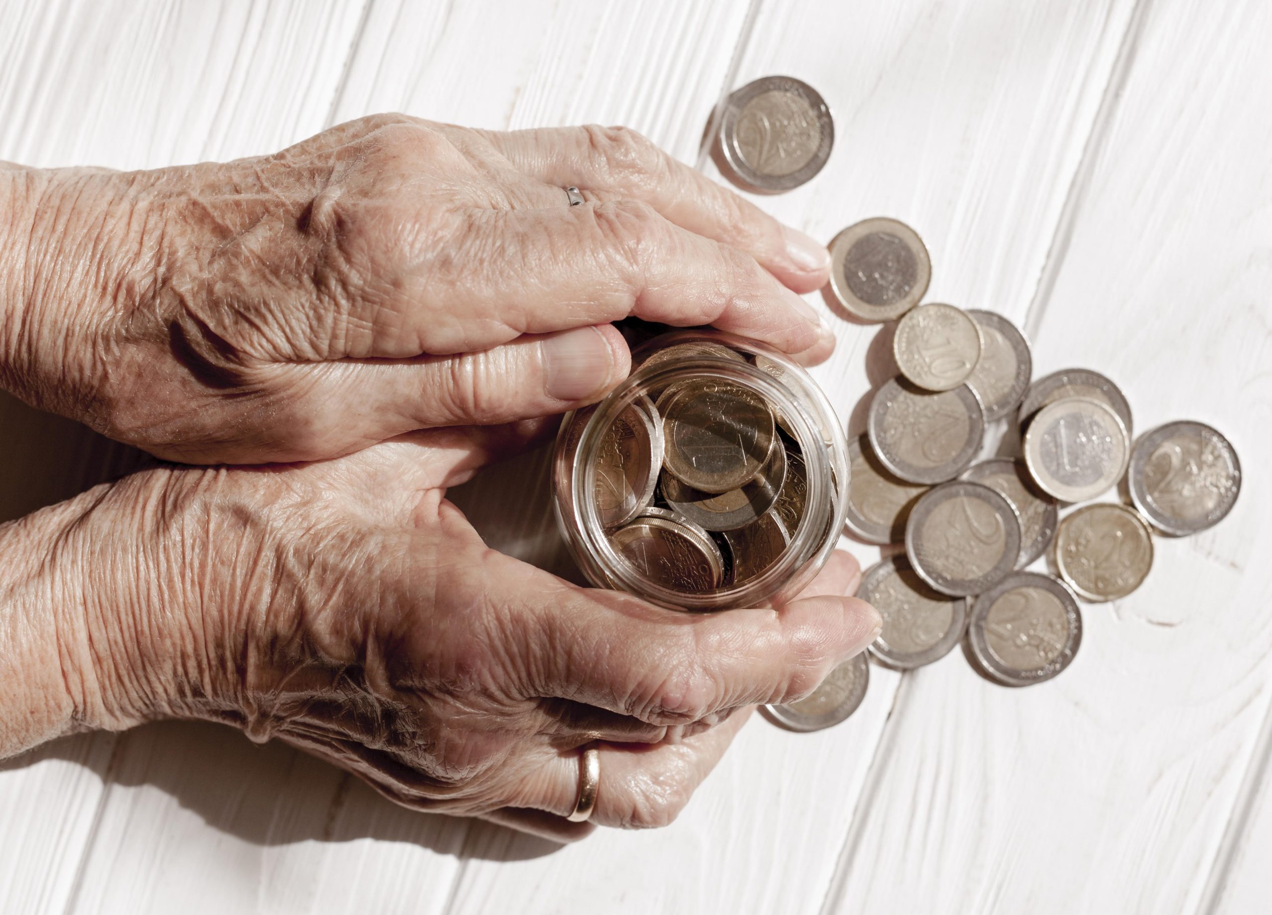 hands-holding-jar-filled-with-coins