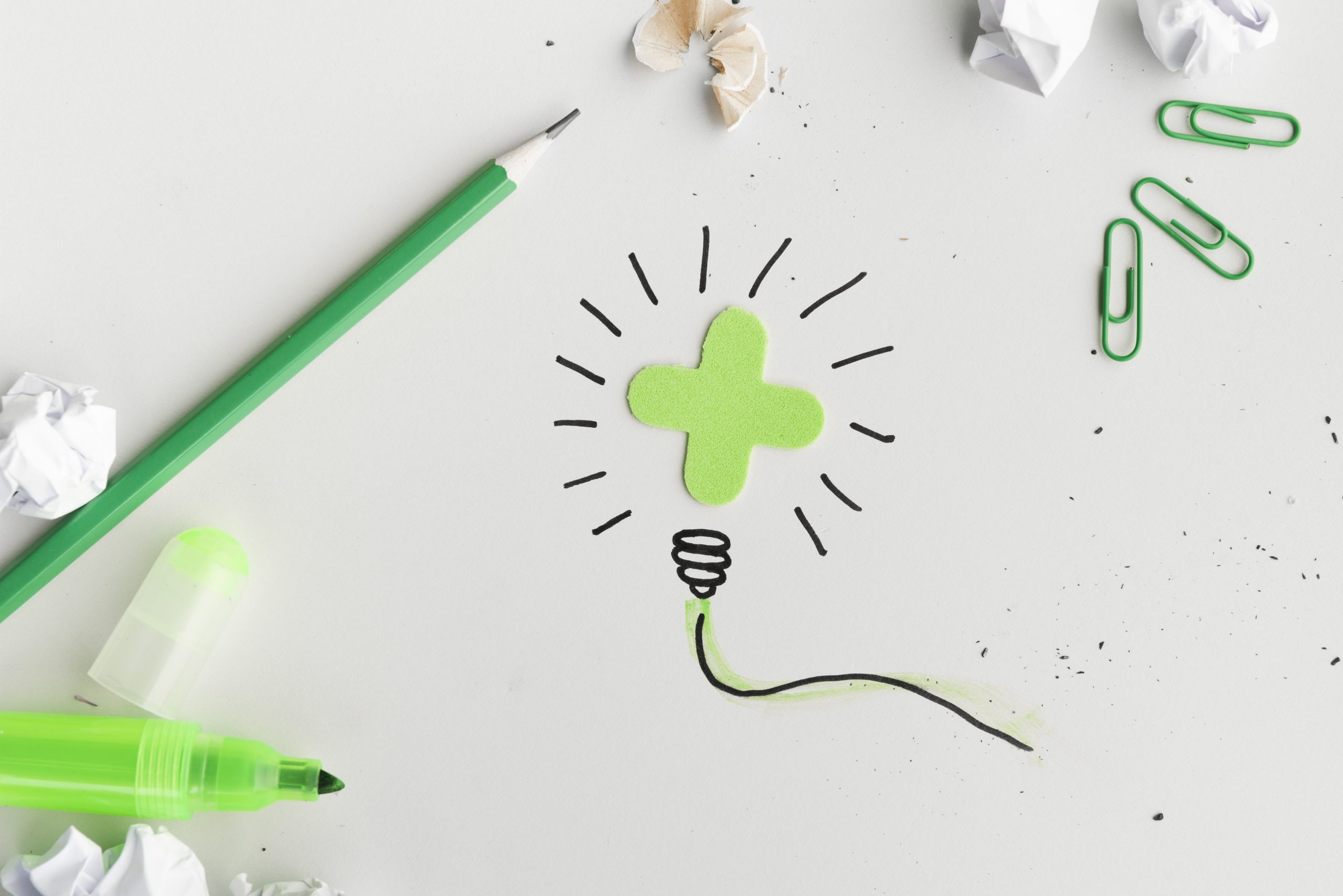 overhead-view-creative-hand-drawn-light-bulb-with-stationery-product-white-surface